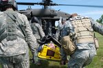 Members of the 101st Civil Support Team of the Idaho National Guard and aircraft crewmembers from the 189th Aviation Regiment move a simulated casualty to an awaiting Black Hawk helicopter to be medically evacuated as part of a WMD training exercise held in Rapid City, S.D., June 19, 2010. The event was part of the South Dakota National Guard's Golden Coyote training exercise.