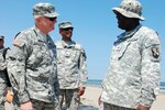 Maj. Gen. Raymond W. Carpenter, acting director of the Army National Guard, National Guard Bureau, speaks with Sgt. Moses Webb, a team leader with the 1022nd Vertical Engineer Company, 527th Engineer Battalion of the Louisiana National Guard. The Guardsmen are performing maintenance on the Tiger Dam water diversion system that acts as a barrier to protect the coastal areas and marshlands from oil in Grand Isle, La., June 24, 2010.