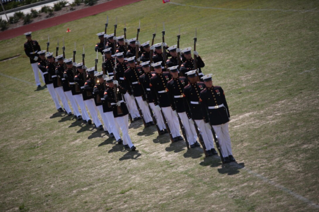 The Marine Corps Silent Drill platoon executes a drill movement while performing during a Battle Colors Ceremony at Marine Corps Support Facility New Orleans, March 17, 2015. Marines from Marine Forces Reserve joined their families and prominent figures from the New Orleans community to watch performances by the band and the Silent Drill Platoon. 