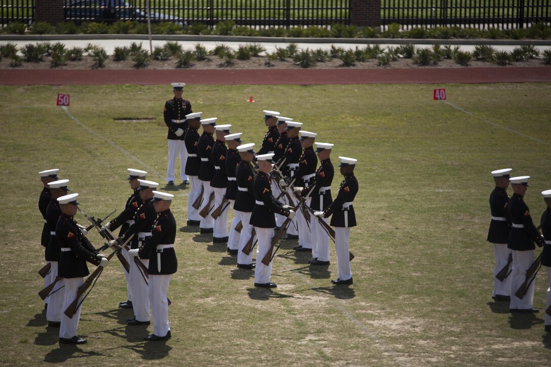 The Marine Corps Silent Drill Platoon executes a drill movement during a Battle Colors Ceremony at Marine Corps Support Facility New Orleans, March 17, 2015. Marines from Marine Forces Reserve joined their families and prominent figures from the New Orleans community to watch the ceremony, which included performances by the Marine Drum and Bugle Corps and the Silent Drill Platoon. 