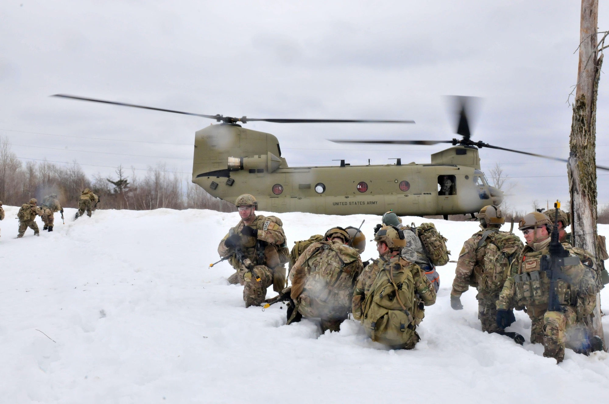 Airmen from the New York Air National Guard's 274th Air Support Operations Squadron wait to board a CH-47 F helicopter from Company B, 2nd Battalion, 126th Aviation of the New York Army National Guard during joint training March 14, 2015, at Fort Drum, N.Y. The two units teamed up to conduct air insertion and tactical training at Fort Drum. (New York Air National Guard photo/Master Sgt. Eric Miller)