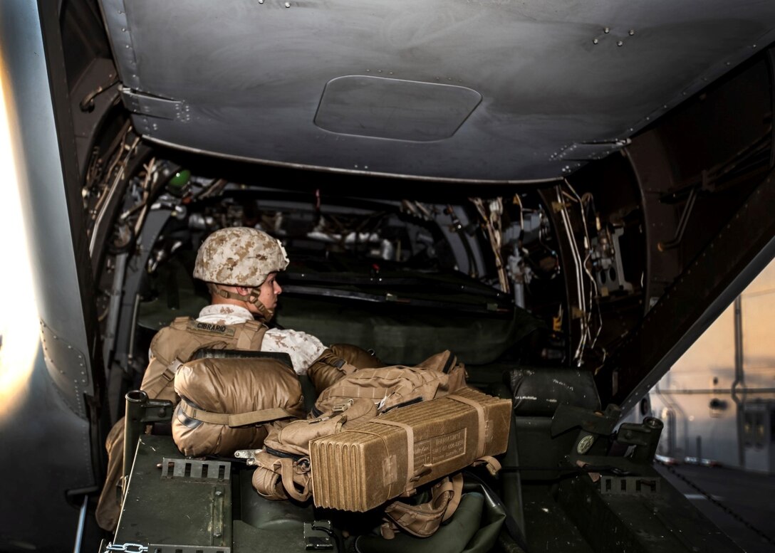 A U.S. Marine with India Battery, Battalion Landing Team 3rd Battalion, 1st Marine Regiment, 15th Marine Expeditionary Unit, practices loading ordnance onto an MV-22B Osprey aboard the USS Essex (LDH 2) during Composite Training Unit Exercise (COMPTUEX) aboard Naval Base San Diego March 17, 2015. The Marines must work together to properly align the ATV with the ramp to successfully load on the ordnance - COMPTUEX is designed to integrate and train the PHIBRON and ship staff as they prepare for deployment later this spring. (U.S. Marine Corps photo by Cpl. Elize McKelvey/Released)
