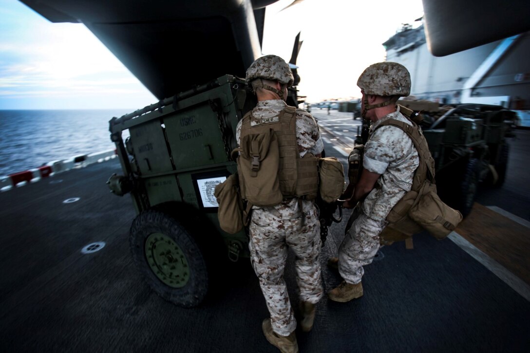 U.S. Marines with India Battery, Battalion Landing Team 3rd Battalion, 1st Marine Regiment, 15th Marine Expeditionary Unit, practice loading ordnance onto an MV-22B Osprey aboard the USS Essex (LDH 2) during Composite Training Unit Exercise (COMPTUEX) aboard Naval Base San Diego March 17, 2015. The Marines must work together to properly align the ATV with the ramp to successfully load on the ordnance - COMPTUEX is designed to integrate and train the PHIBRON and ship staff as they prepare for deployment later this spring. (U.S. Marine Corps photo by Cpl. Elize McKelvey/Released)