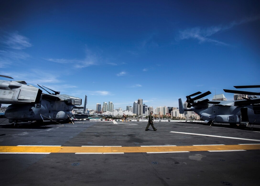 A U.S. Marine walks on the flight deck of the USS Essex (LHD 2) as she departs to begin Composite Training Unit Exercise (COMPTUEX) aboard Naval Base San Diego March 16, 2015. The 15th MEU is embarked aboard the three ships of the Essex Amphibious Ready Group - the USS Essex, USS Anchorage (LPD 23), and USS Rushmore (LSD 47) – during COMPTUEX to continue integrating and training with the PHIBRON and ship staffs as they prepare for deployment later this spring. (U.S. Marine Corps photo by Cpl. Elize McKelvey/Released)