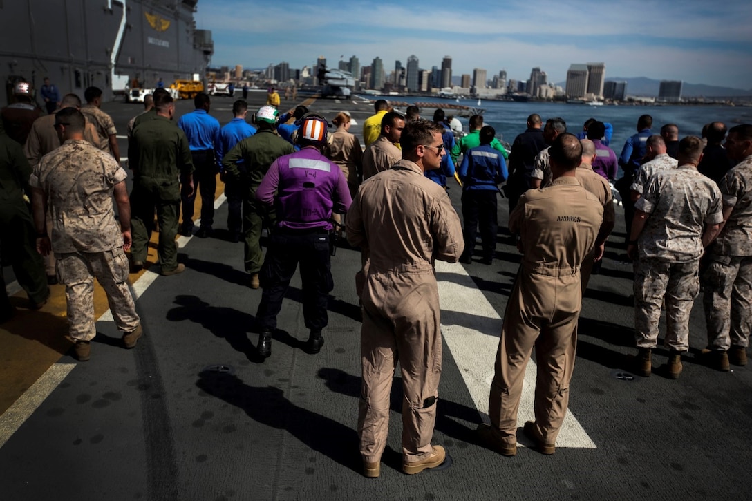 U.S. Marines and Sailors perform a foreign object damage walk on the flight deck of the USS Essex (LHD 2) during Composite Training Unit Exercise (COMPTUEX) aboard Naval Base San Diego March 16, 2015. FOD walks are performed on multiple occasions to clear the flight deck of any rocks and debris that could interfere with flight operations. (U.S. Marine Corps photo by Cpl. Elize McKelvey/Released)