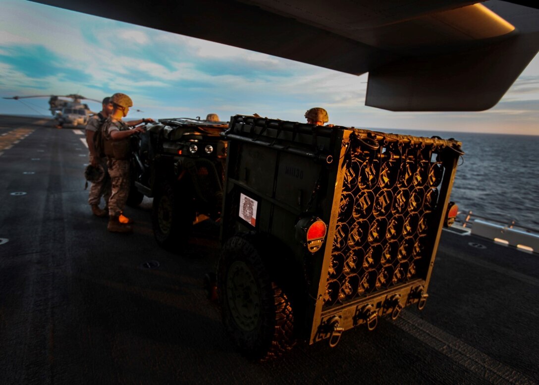 U.S. Marines with India Battery, Battalion Landing Team 3rd Battalion, 1st Marine Regiment, 15th Marine Expeditionary Unit, practice loading ordnance onto an MV-22B Osprey aboard the USS Essex (LDH 2) during Composite Training Unit Exercise (COMPTUEX) aboard Naval Base San Diego March 17, 2015. The Marines must work together to properly align the ATV with the ramp to successfully load on the ordnance - COMPTUEX is designed to integrate and train the PHIBRON and ship staff as they prepare for deployment later this spring. (U.S. Marine Corps photo by Cpl. Elize McKelvey/Released)
