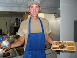 Sgt. First Class Mike Larey, a Louisiana National Guard member and the head cook for Task Force Kout Men, serves up an authentic Louisiana-style meal to troops of the New Horizons-Haiti 2010 training exercise. Larey trained as a chef at the Peabody Hotel in Memphis, Tenn., BB Kings in Memphis, Tenn., and Dragos restaurant in New Orleans.