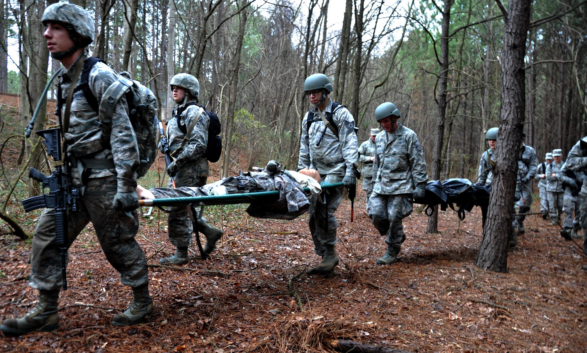 Airmen from the 911th Force Support Squadron, Pittsburgh, Pa., carry casualty dummies during OPERATION Everybody Panic as part of Force Support Silver Flag at Dobbins Air Reserve Base, Ga., March 10, 2015. The challenge consisted of teams competing against each other in nine different events ranging from following a convoy, building tents, fixing Babington burners, cooking meals, planning lodging, planning a base from scratch, driving a forklift and a scavenger hunt. (U.S. Air Force photo/Senior Airman Daniel Phelps)