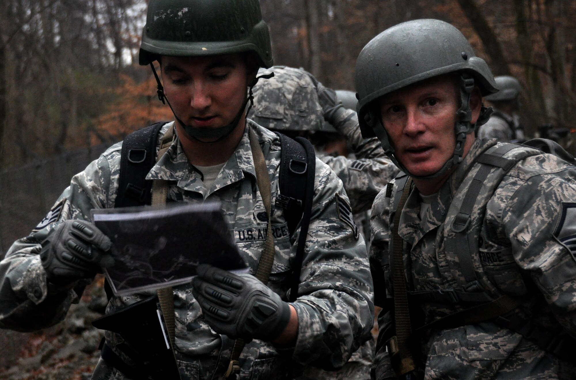 Staff Sgt. Daniel Chrest and Master Sgt. Mark Ansani, 911th Force Support Squadron, Pittsburgh, Pa., plot out their route on a map during OPERATION Everybody Panic as part of Force Support Silver Flag at Dobbins Air Reserve Base, Ga., March 10, 2015. Teams were tasked with engaging targets, self-aid buddy care, providing care under fire, identifying unexploded ordnances and improvised explosive devices, describing and providing the location of the UXOs and IEDs on a grid, low and high crawling, and transporting remains during this scenario.  (U.S. Air Force photo/Senior Airman Daniel Phelps)