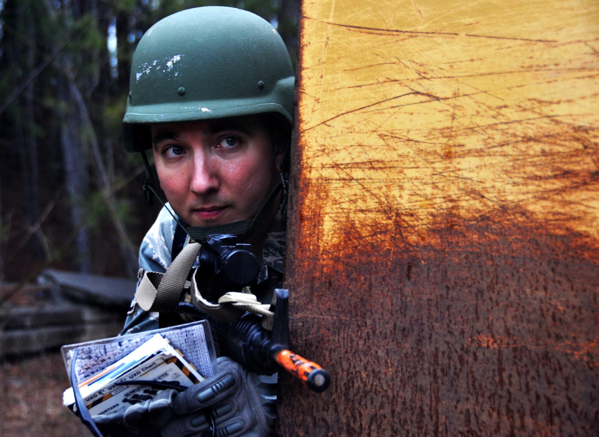 Staff Sgt. Daniel Chrest, 911th Force Support Squadron, Pittsburgh, Pa., takes cover from an attack during OPERATION Everybody Panic as part of Force Support Silver Flag at Dobbins Air Reserve Base, Ga., March 10, 2015. Teams were tasked with engaging targets, self-aid buddy care, providing care under fire, identifying unexploded ordnances and improvised explosive devices, describing and providing the location of the UXOs and IEDs on a grid, low and high crawling, and transporting remains during this scenario. (U.S. Air Force photo/Senior Airman Daniel Phelps)