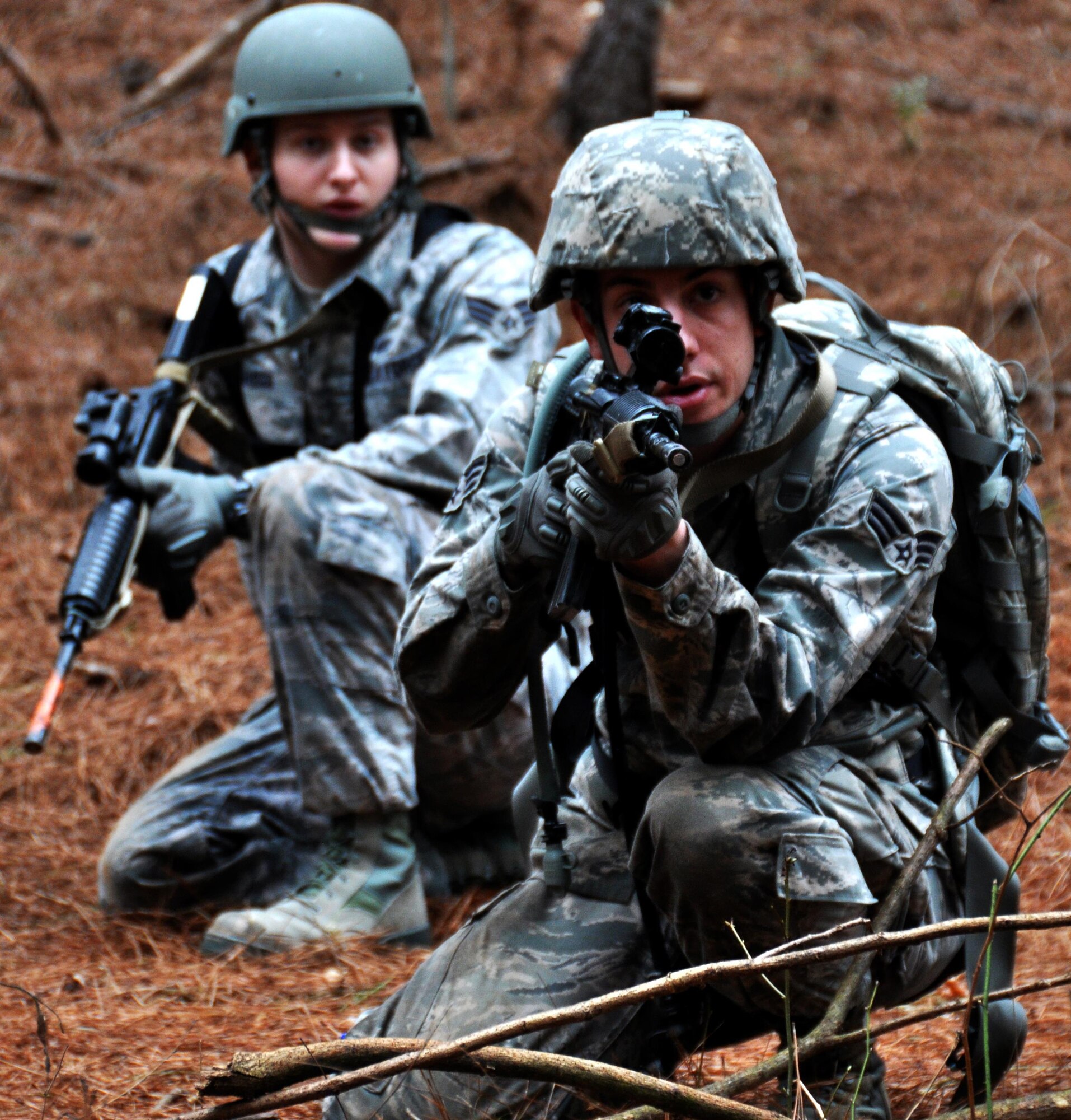 Senior Airmen Tyler Wright and Dominic Maggs, 911th Force Support Squadron, Pittsburgh, Pa., scout out for the enemy to recover a casualty dummy during OPERATION Everybody Panic as part of Force Support Silver Flag at Dobbins Air Reserve Base, Ga., March 10, 2015. Teams were tasked with engaging targets, self-aid buddy care, providing care under fire, identifying unexploded ordnances and improvised explosive devices, describing and providing the location of the UXOs and IEDs on a grid, low and high crawling, and transporting remains during this scenario.  (U.S. Air Force photo/Senior Airman Daniel Phelps)