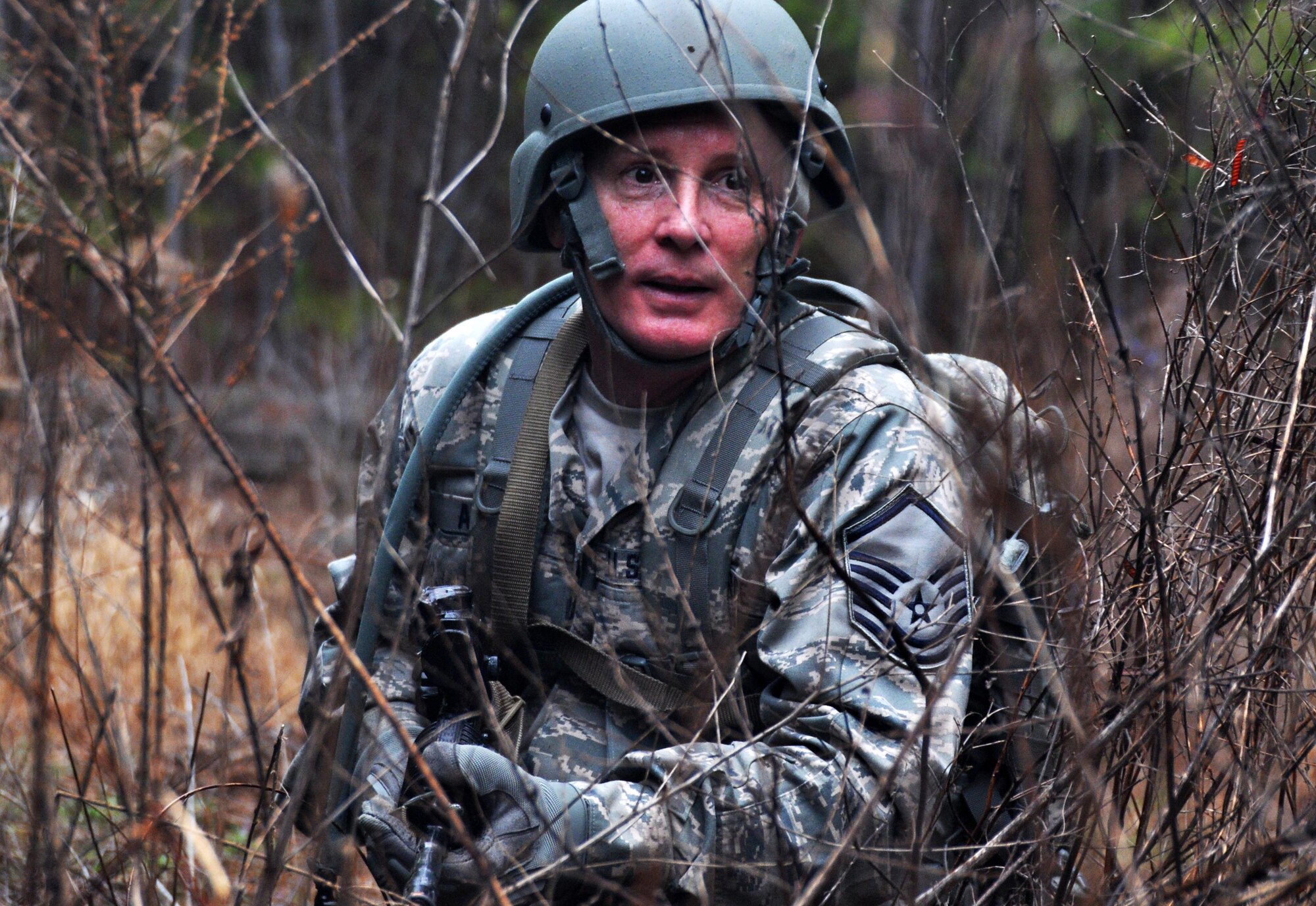 Master Sgt. Mark Ansani, 911th Force Support Squadron, Pittsburgh, Pa., scouts the area to ensure the unit is not attacked again during OPERATION Everybody Panic as part of Force Support Silver Flag at Dobbins Air Reserve Base, Ga., March 10, 2015. Teams were tasked with engaging targets, self-aid buddy care, providing care under fire, identifying unexploded ordnances and improvised explosive devices, describing and providing the location of the UXOs and IEDs on a grid, low and high crawling, and transporting remains during this scenario. (U.S. Air Force photo/Senior Airman Daniel Phelps)