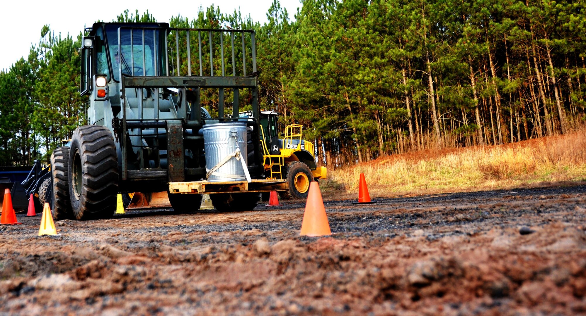 A forklift carrying a trash can full of water attempts to maneuver through the cones without spilling any water during Force Support Silver Flag at Dobbins Air Reserve Base, Georgia, March 11, 2015. About 70 Airmen on teams from Peterson Air Force Base, Colorado; the 445th FSS from Wright-Patterson Air Force Base, Ohio; the 908th FSS from Maxwell AFB, Alabama; the 910th FSS from Youngstown ARB, Ohio; the 911th FSS from Pittsburgh, Pennsylvania; and the 934th FSS from Minneapolis – St. Paul, Minnesota competed in FS Silver Flag. (U.S. Air Force photo/Senior Airman Daniel Phelps)