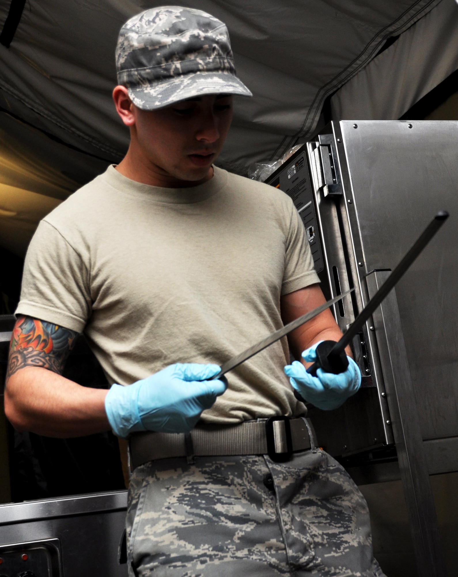 Senior Airman Fa Pham, 911th Force Support Squadron, Pittsburgh, Pa., sharpens a knife for meal preparations during the Readiness Challenge for Force Support Silver Flag at Dobbins Air Reserve Base, Georgia, March 11, 2015. About 70 Airmen on teams from Peterson Air Force Base, Colorado; the 445th FSS from Wright-Patterson Air Force Base, Ohio; the 908th FSS from Maxwell AFB, Alabama; the 910th FSS from Youngstown ARB, Ohio; the 911th FSS from Pittsburgh, Pennsylvania; and the 934th FSS from Minneapolis – St. Paul, Minnesota competed in FS Silver Flag.  (U.S. Air Force photo/Senior Airman Daniel Phelps)