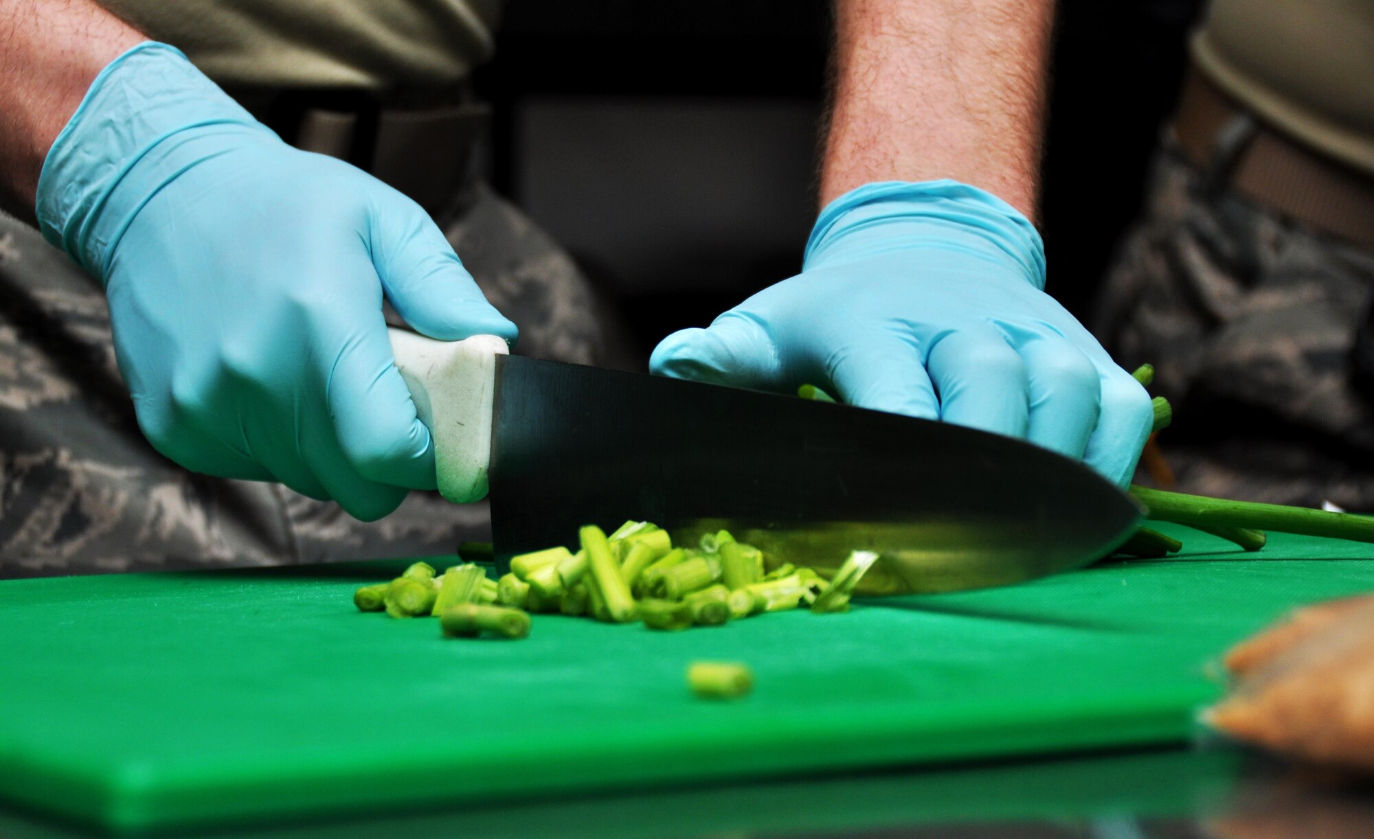 Senior Airman Dominic Maggs, 911th Force Support Squadron, Pittsburgh, Pa., chops green onions for meal preparations during the Readiness Challenge for Force Support Silver Flag at Dobbins Air Reserve Base, Georgia, March 11, 2015. About 70 Airmen on teams from Peterson Air Force Base, Colorado; the 445th FSS from Wright-Patterson Air Force Base, Ohio; the 908th FSS from Maxwell AFB, Alabama; the 910th FSS from Youngstown ARB, Ohio; the 911th FSS from Pittsburgh, Pennsylvania; and the 934th FSS from Minneapolis – St. Paul, Minnesota competed in FS Silver Flag.  (U.S. Air Force photo/Senior Airman Daniel Phelps)