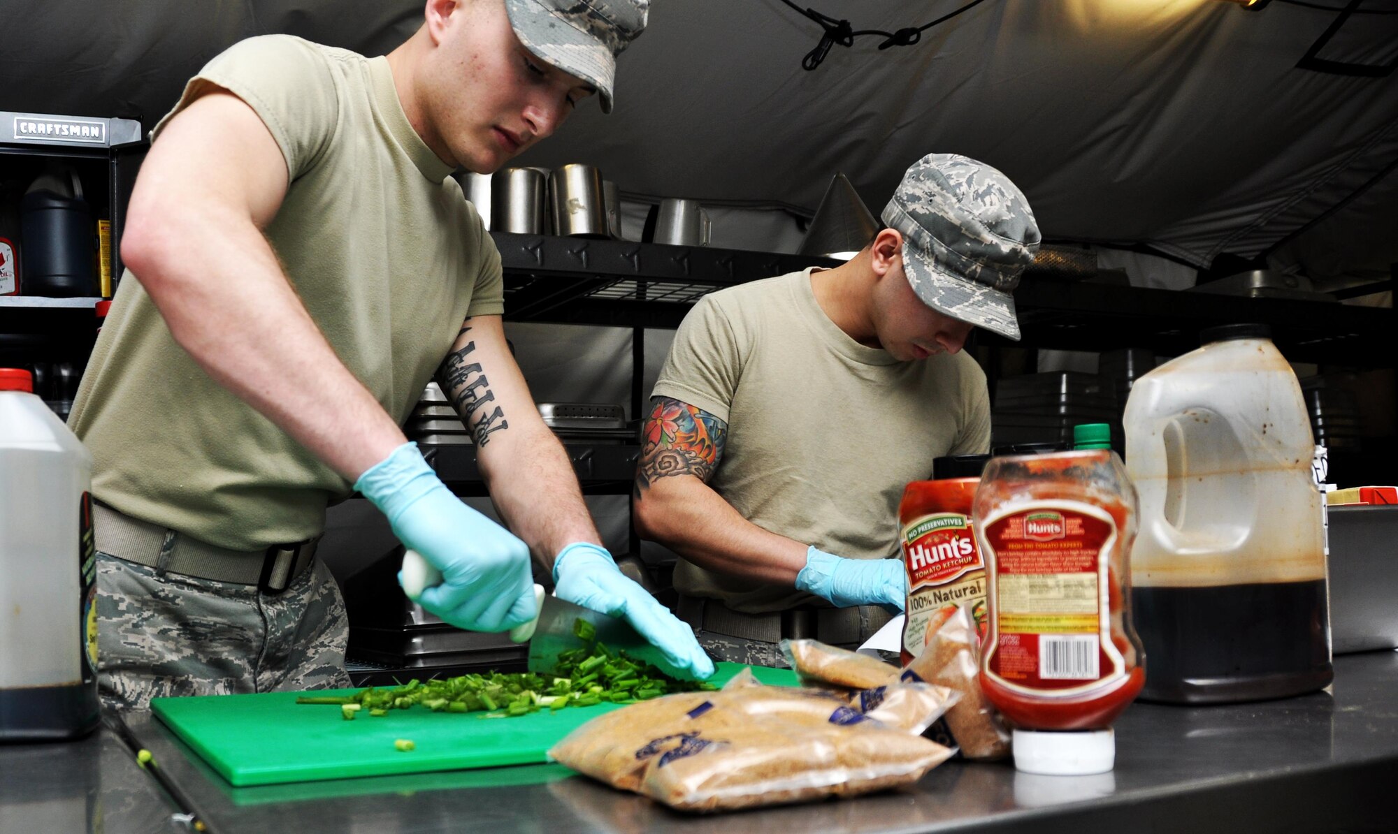 Senior Airmen Dominic Maggs and Fa Pham, both 911th Force Support Squadron, Pittsburgh, Pa., prepare food for dinner during the Readiness Challenge for Force Support Silver Flag at Dobbins Air Reserve Base, Georgia, March 11, 2015. About 70 Airmen on teams from Peterson Air Force Base, Colorado; the 445th FSS from Wright-Patterson Air Force Base, Ohio; the 908th FSS from Maxwell AFB, Alabama; the 910th FSS from Youngstown ARB, Ohio; the 911th FSS from Pittsburgh, Pennsylvania; and the 934th FSS from Minneapolis – St. Paul, Minnesota competed in FS Silver Flag. (U.S. Air Force photo/Senior Airman Daniel Phelps)