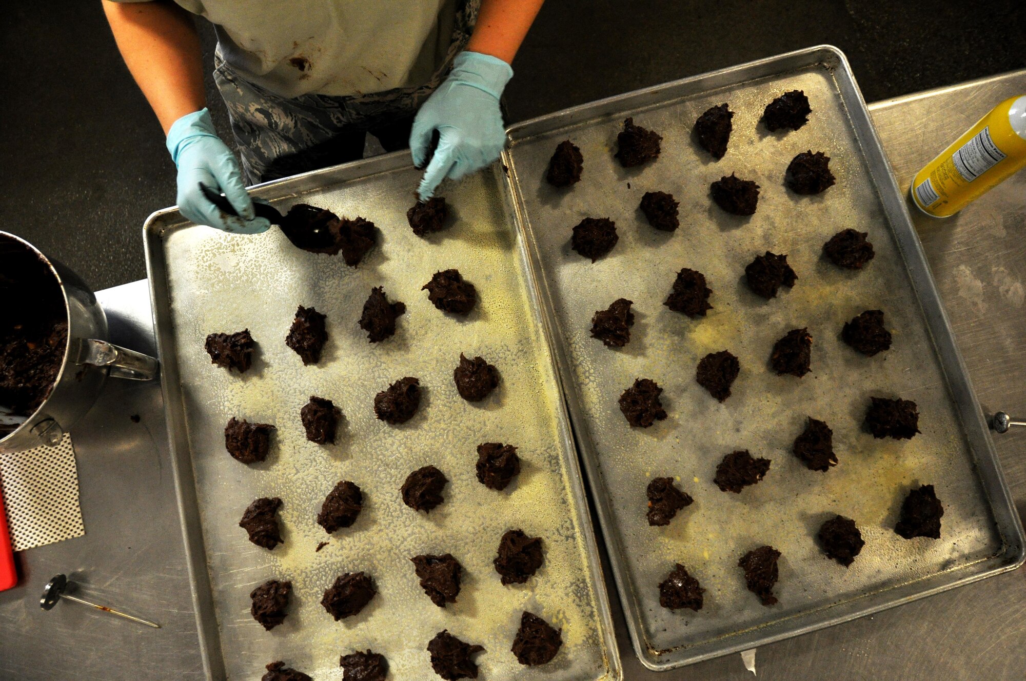 Staff Sgt. Kelsey Ansen, 911th Force Support Squadron, Pittsburgh, Pa., places cookie dough on a baking tray during the Readiness Challenge for Force Support Silver Flag at Dobbins Air Reserve Base, Georgia, March 11, 2015. The challenge consisted of teams competing against each other in nine different events ranging from following a convoy, building tents, fixing Babington burners, cooking meals, planning lodging, planning a base from scratch, driving a forklift and a scavenger hunt. (U.S. Air Force photo/Senior Airman Daniel Phelps)