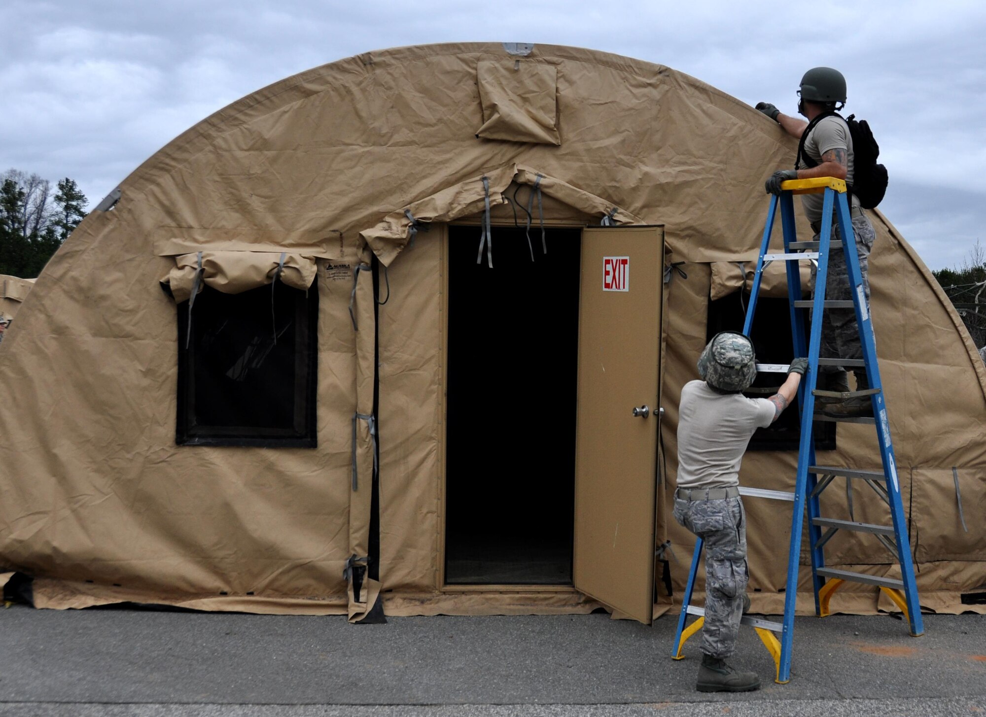 Airmen from the 911th Force Support Squadron, Pittsburgh, Pa. connect the walls of a tent to its poles during the Readiness Challenge for Force Support Silver Flag at Dobbins Air Reserve Base, Georgia, March 12, 2015. The challenge consisted of teams competing against each other in nine different events ranging from following a convoy, building tents, fixing Babington burners, cooking meals, planning lodging, planning a base from scratch, driving a forklift and a scavenger hunt. (U.S. Air Force photo/Senior Airman Daniel Phelps)