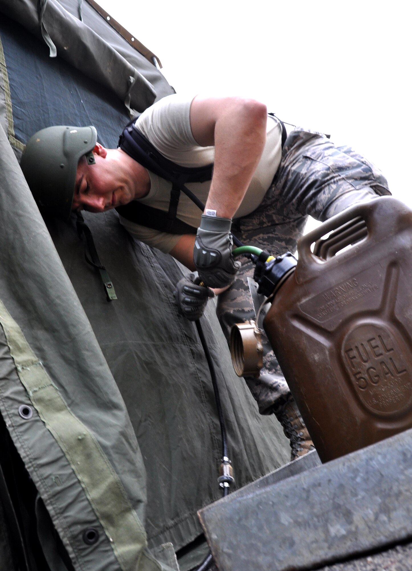 Staff Sgt. Daniel Chrest, 911th Force Support Squadron, Pittsburgh, Pa., connects fuel line to a tank for the field kitchen during the Readiness Challenge for Force Support Silver Flag at Dobbins Air Reserve Base, Georgia, March 12, 2015. The challenge consisted of teams competing against each other in nine different events ranging from following a convoy, building tents, fixing Babington burners, cooking meals, planning lodging, planning a base from scratch, driving a forklift and a scavenger hunt. (U.S. Air Force photo/Senior Airman Daniel Phelps)