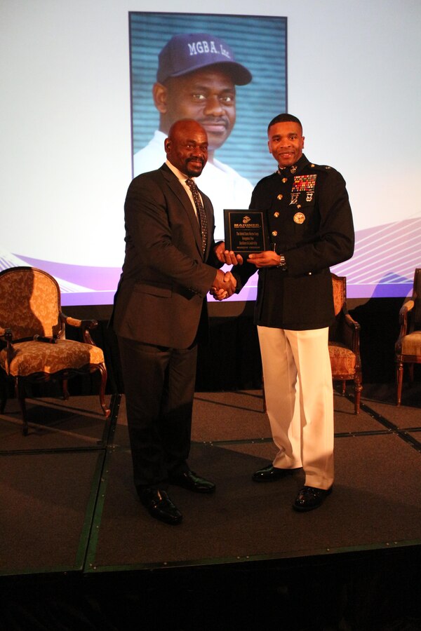 Marquis Grissom, an alumnus of Florida Agricultural and Mechanical University is presented with the Marine Corps Excellence in Leadership award by U.S. Marine Corps Lt. Col. Ricardo T. Player, the Marine Forces Command Director of Public Affairs, at the Mid-Eastern Athletic Conference Hall of Fame brunch in Norfolk, Virginia, March 13, 2015. The award recognizes the hard work and dedication of people who positively affect their communities. (U.S. Marine Corps Photo by Sgt. Nicholas S. Ranum/Released)