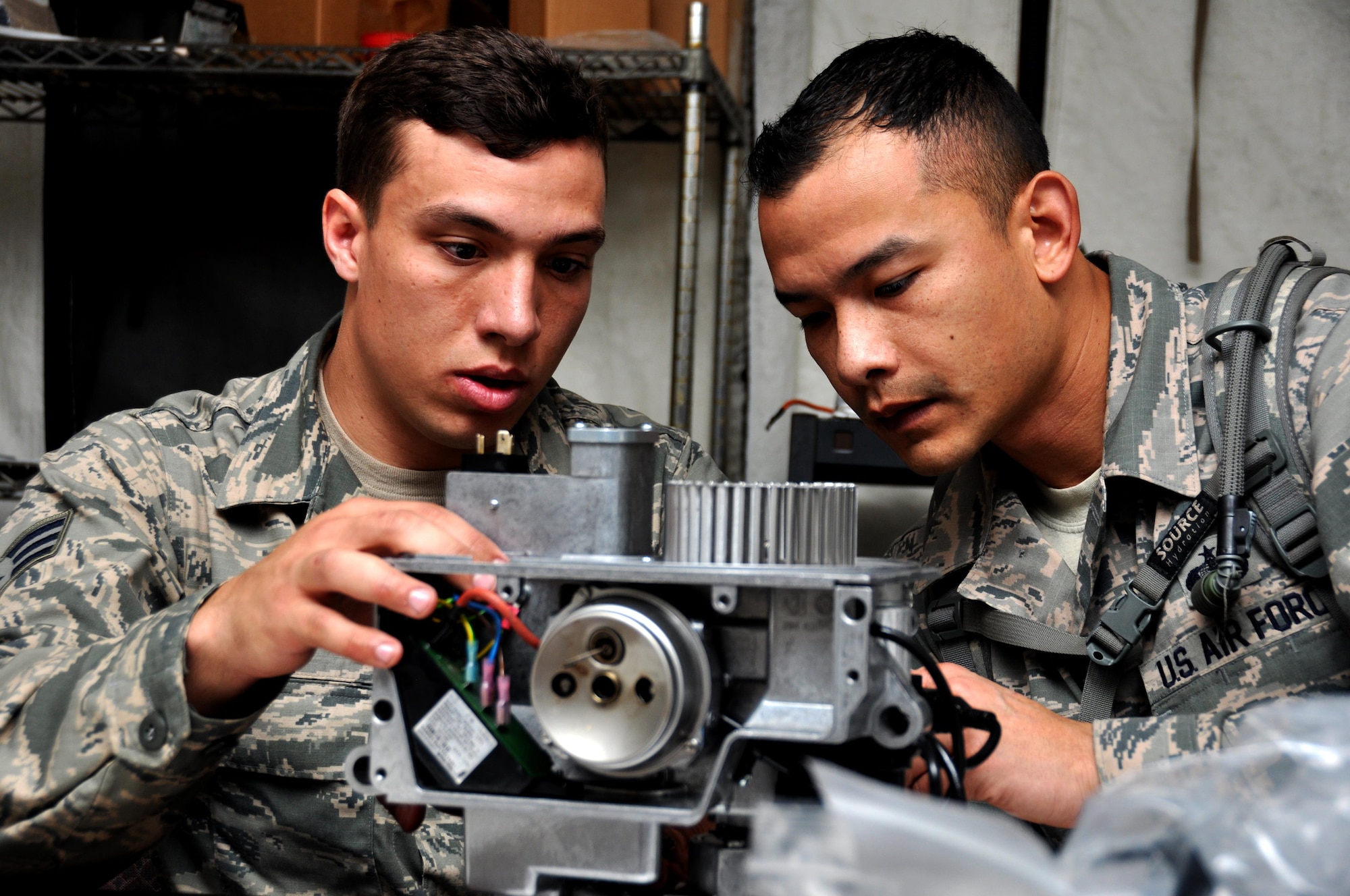 Senior Airman Aaron Voe and Tech. Sgt. Fanor Ramos, both from the 21st Force Support Squadron at Peterson Air Force Base, Colo., put together a Babington Burner competition during the Readiness Challenge for Force Support Silver Flag at Dobbins Air Reserve Base, Georgia, March 12, 2015. Two teams competed to see who could take apart and put back their burner together in working condition the fastest in this portion of the challenge. (U.S. Air Force photo/Senior Airman Daniel Phelps)