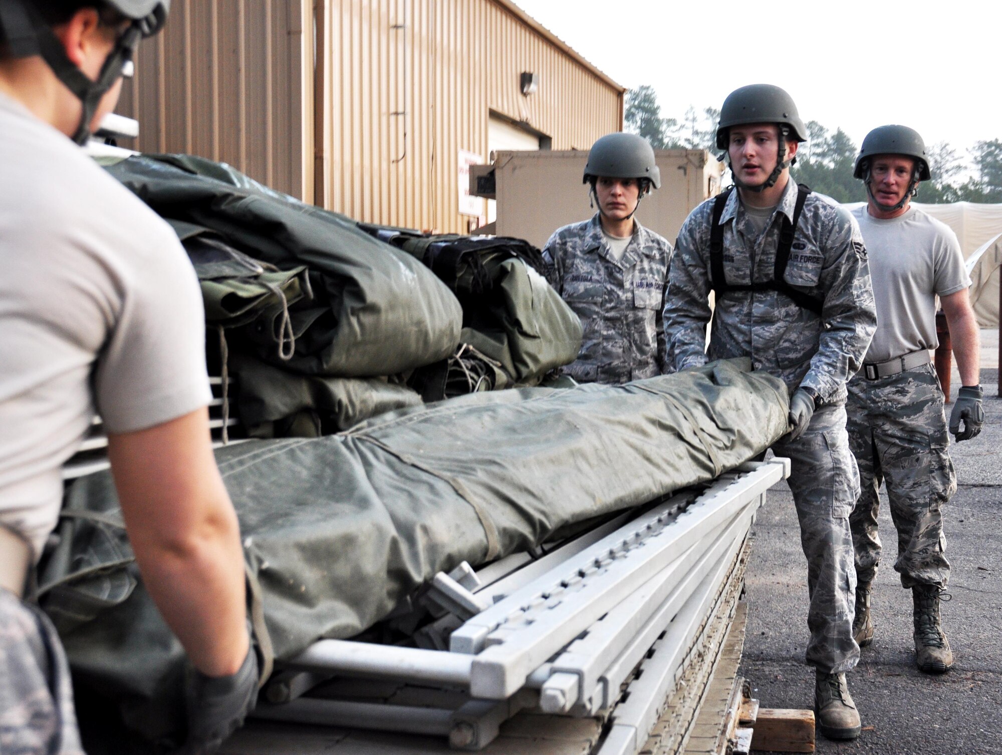 Airmen from the 911th Force Support Squadron, Pittsburgh, Pa. lift poles for a tent during the Readiness Challenge for Force Support Silver Flag at Dobbins Air Reserve Base, Georgia, March 12, 2015. About 70 Airmen on teams from Peterson Air Force Base, Colorado; the 445th FSS from Wright-Patterson Air Force Base, Ohio; the 908th FSS from Maxwell AFB, Alabama; the 910th FSS from Youngstown ARB, Ohio; the 911th FSS from Pittsburgh, Pennsylvania; and the 934th FSS from Minneapolis – St. Paul, Minnesota competed in FS Silver Flag. (U.S. Air Force photo/Senior Airman Daniel Phelps)