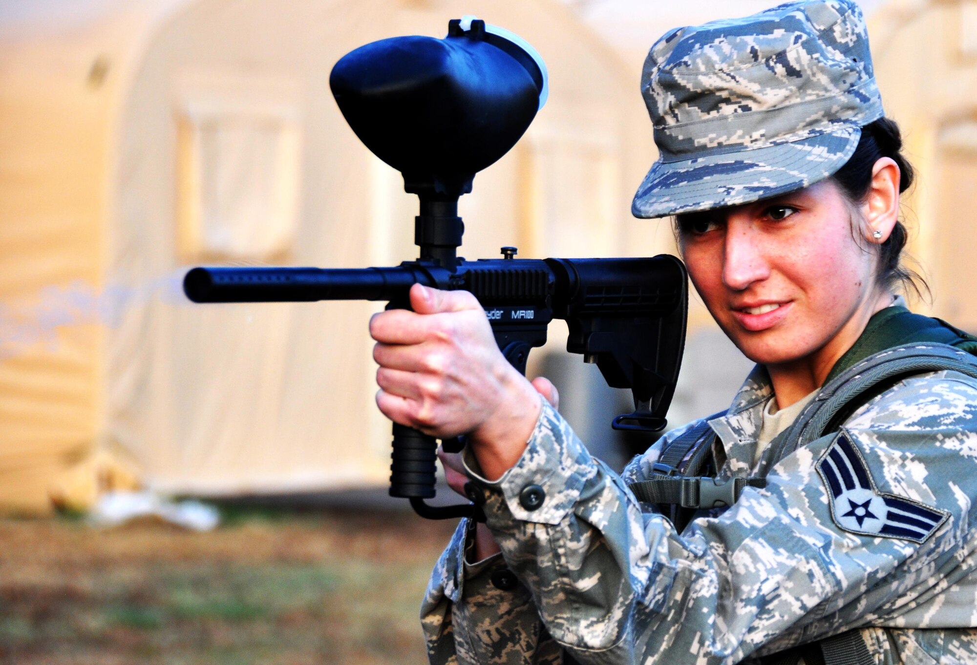 Senior Airman Jessica McMillan, 445th Force Support Squadron at Wright Patterson Air Force Base, Ohio, fires a paintball gun at a target for the scavenger hunt portion of the Readiness Challenge for Force Support Silver Flag at Dobbins Air Reserve Base, Georgia, March 12, 2015. The numbers hit on the target represent how many push-ups her team would have to complete before receiving their next clue. (U.S. Air Force photo/Senior Airman Daniel Phelps)