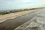 Tiger Dam barrier walls emplaced by Louisiana National Guardsmen protect inland areas in Grand Isle, La., from the effects of wave action caused by Tropical Storm Alex, June 29, 2010. Coastal barriers such as this, land bridges, sandbags, and Hesco walls have been constructed to close gaps and protect low-lying sections along the coast from possible oil intrusion.