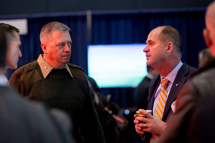 LtCol Patrick Kirchner, with the Futures Directorate's Futures Assessment Division, listens as a visitor to the Naval Future Force Expo explains a potential solution to one of the Navy and Marine Corps' S&T challenges.