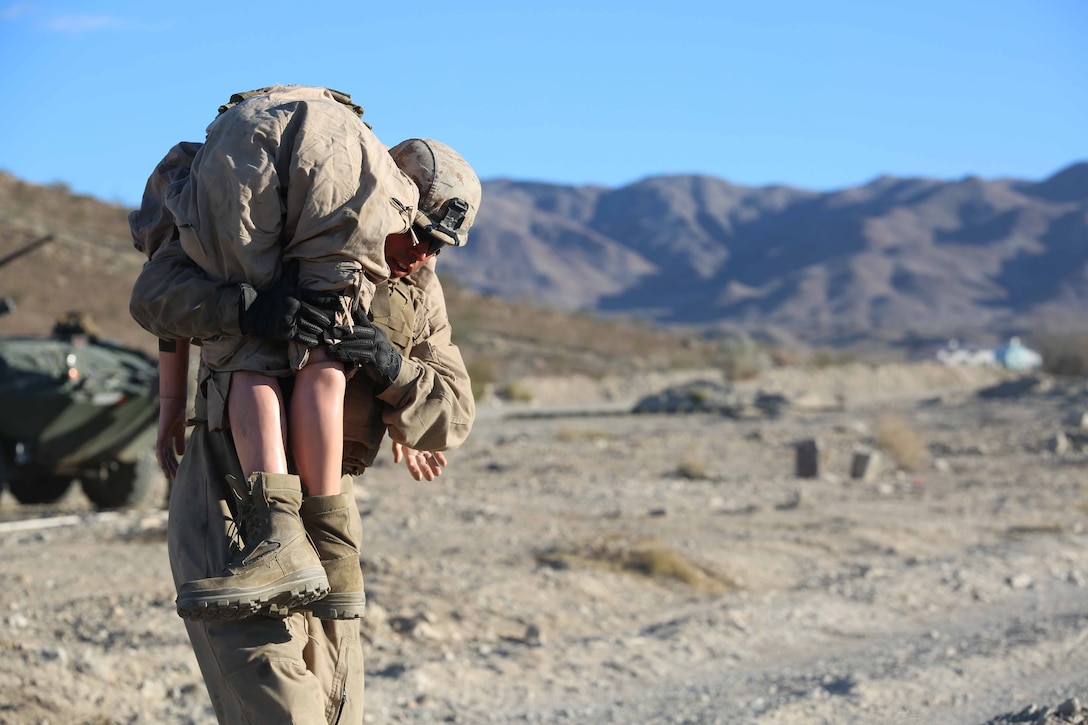 Cpl. Jeff Flores, driver, Light Armored Vehicle Platoon, Company B, Ground Combat Element Integrated Task Force, conducts a simulated casualty evacuation portion of a Marine Corps Operational Test and Evaluation Activity assessment at Range 500, Marine Corps Air Ground Combat Center Twentynine Palms, California, March 12, 2015. From October 2014 to July 2015, the GCEITF will conduct individual and collective level skills training in designated ground combat arms occupational specialties in order to facilitate the standards-based assessment of the physical performance of Marines in a simulated operating environment performing specific ground combat arms tasks. (U.S. Marine Corps photo by Cpl. Paul S. Martinez/Released)