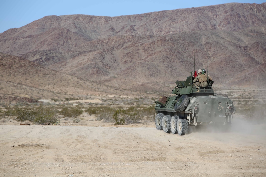 Marines with Light Armored Vehicle Platoon, Company B, Ground Combat Element Integrated Task Force, roll out to the firing line during a Marine Corps Operational Test and Evaluation Activity assessment at Range 500, Marine Corps Air Ground Combat Center Twentynine Palms, California, March 10, 2015. From October 2014 to July 2015, the GCEITF will conduct individual and collective level skills training in designated ground combat arms occupational specialties in order to facilitate the standards-based assessment of the physical performance of Marines in a simulated operating environment performing specific ground combat arms tasks. (U.S. Marine Corps photo by Cpl. Paul S. Martinez/Released)