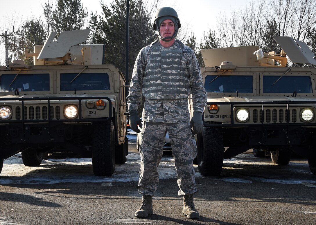 Tech. Sgt. John Davis, 911th Security Forces fire team leader, stands in front of two Humvees awaiting pre-checks during convoy training at the 911th Airlift Wing, March 8, 2015. Tech. Sgt. Davis is being honored nationally at the Reserve Officers Association annual gala as a Reserve Sentry Spotlight on March 17, 2015. (U.S. Air Force photo by Staff Sgt. Justyne Obeldobel)