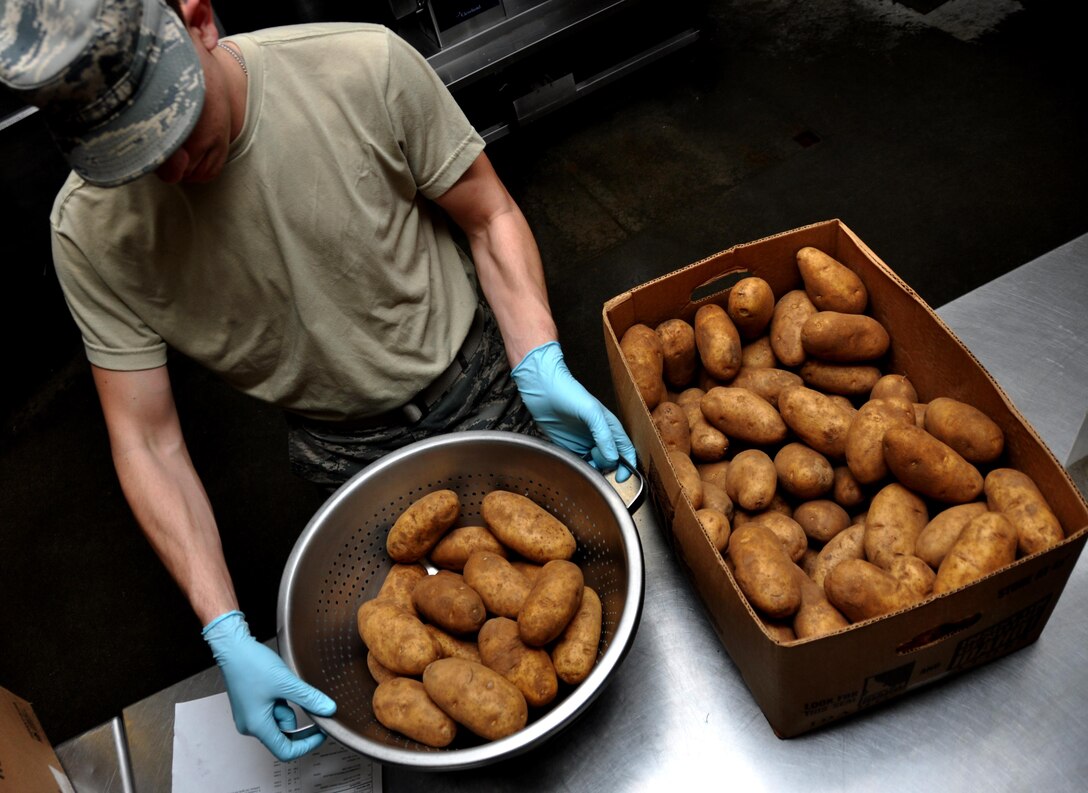 Senior Airmen Tyler Wright, 911th Force Support Squadron, Pittsburgh, Pa., sorts potatoes for a meal during the Readiness Challenge for Force Support Silver Flag at Dobbins Air Reserve Base, Georgia, March 11, 2015. The challenge consisted of teams competing against each other in nine different events ranging from following a convoy, building tents, fixing Babington burners, cooking meals, planning lodging, planning a base from scratch, driving a forklift and a scavenger hunt. (U.S. Air Force photo/Senior Airman Daniel Phelps)
