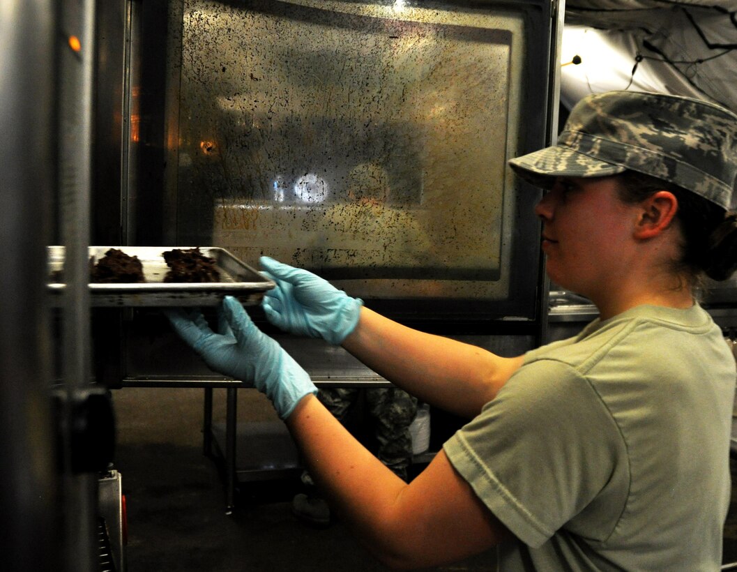 Staff Sgt. Kelsey Ansen, 911th Force Support Squadron, Pittsburgh, Pa., places cookies into an oven to bake them for dessert during the Readiness Challenge for Force Support Silver Flag at Dobbins Air Reserve Base, Georgia, March 11, 2015. About 70 Airmen on teams from Peterson Air Force Base, Colorado; the 445th FSS from Wright-Patterson Air Force Base, Ohio; the 908th FSS from Maxwell AFB, Alabama; the 910th FSS from Youngstown ARB, Ohio; the 911th FSS from Pittsburgh, Pennsylvania; and the 934th FSS from Minneapolis – St. Paul, Minnesota competed in FS Silver Flag. (U.S. Air Force photo/Senior Airman Daniel Phelps)