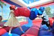 Children box in a bounce house during the DM50 picnic at Davis-Monthan Air Force Base, Ariz., March 14, 2015. The picnic was a free event for active duty members, families, retirees and any guests sponsored onto the base. (U.S. Air Force photo by Airman 1st Class Chris Massey/Released)