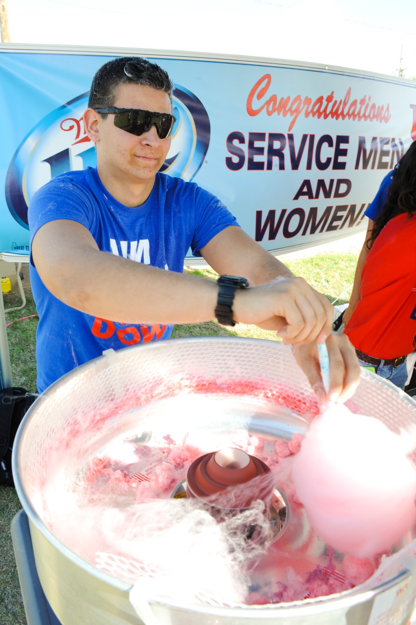 U.S. Air Force cadet Nicholas Petropoulos, makes cotton candy for participants of the DM50 picnic at Davis-Monthan Air Force Base, Ariz., March 14, 2015.  The picnic provided a variety of free entertainment, food and events to approximately 3,600 people. (U.S. Air Force photo by Staff Sgt. Angela Ruiz/Released) 