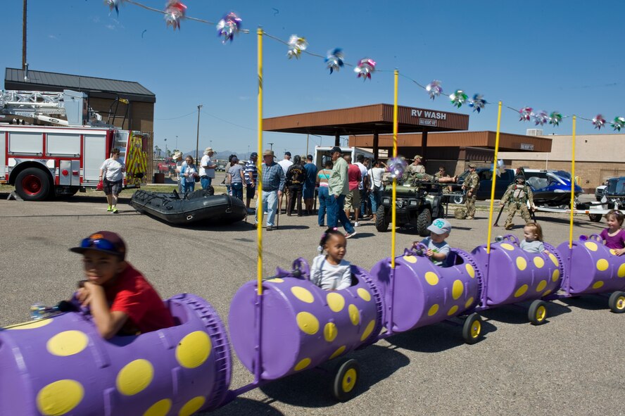 Children explore multiple rides and information stands during the DM50 picnic Davis-Monthan Air Force Base, Ariz., March 14, 2015. The picnic was a free event for active duty members, families, retirees and any guests sponsored onto the base. (U.S. Air Force photo by Staff Sgt. Angela Ruiz/Released)