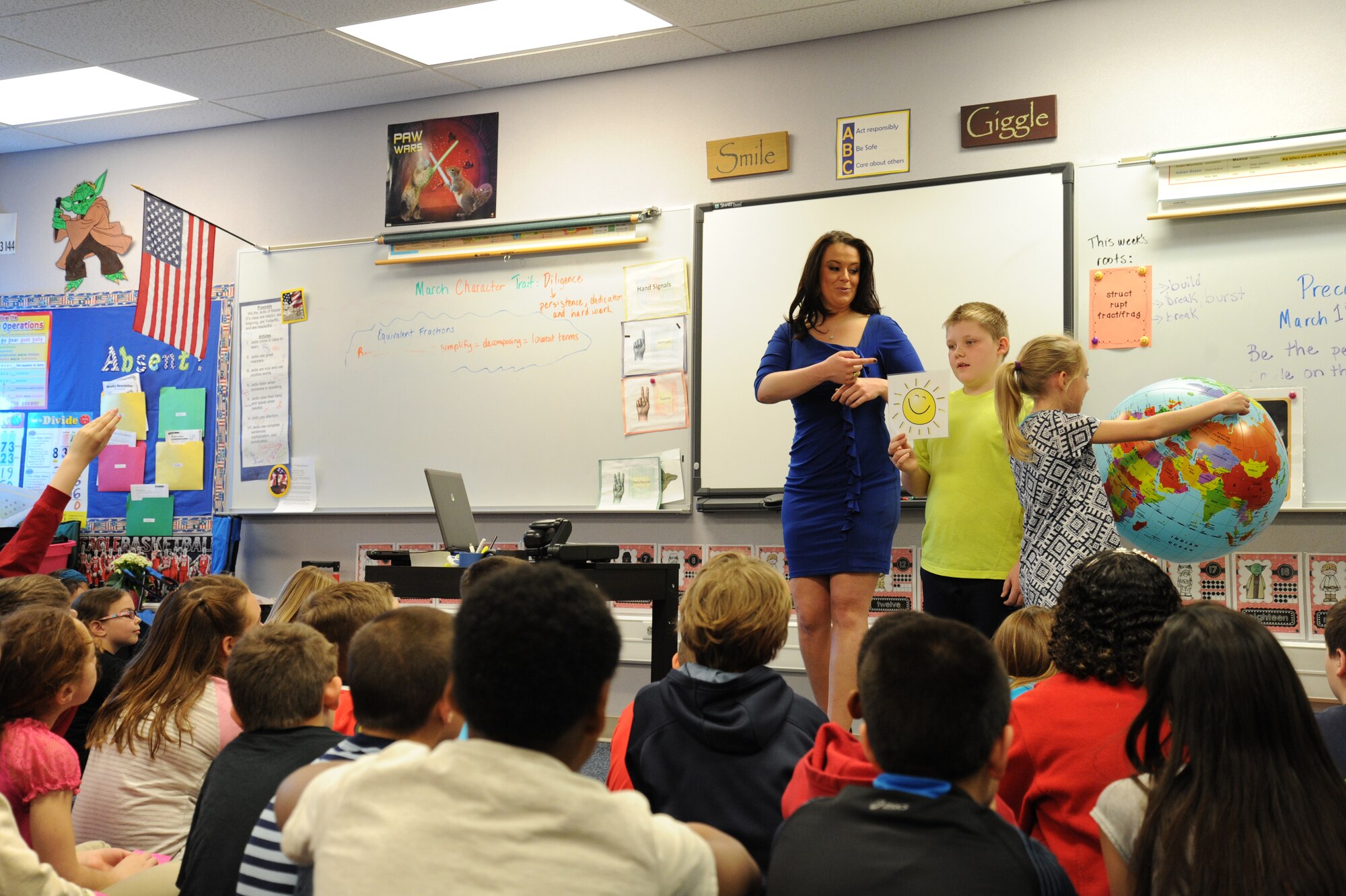 Katie Boer, KREM 2 NEWS weather anchor, teaches students about the effects of the Earth’s rotation around the sun March 18, 2015, at Fairchild Air Force Base, Wash. Boer brought hands-on items to include an inflatable globe so the students could get a visual on how the Earth rotates around the sun, a green screen and a paper bag to simulate thunder. (U.S. Air Force photo/Airman 1st Class Nicolo J. Daniello)