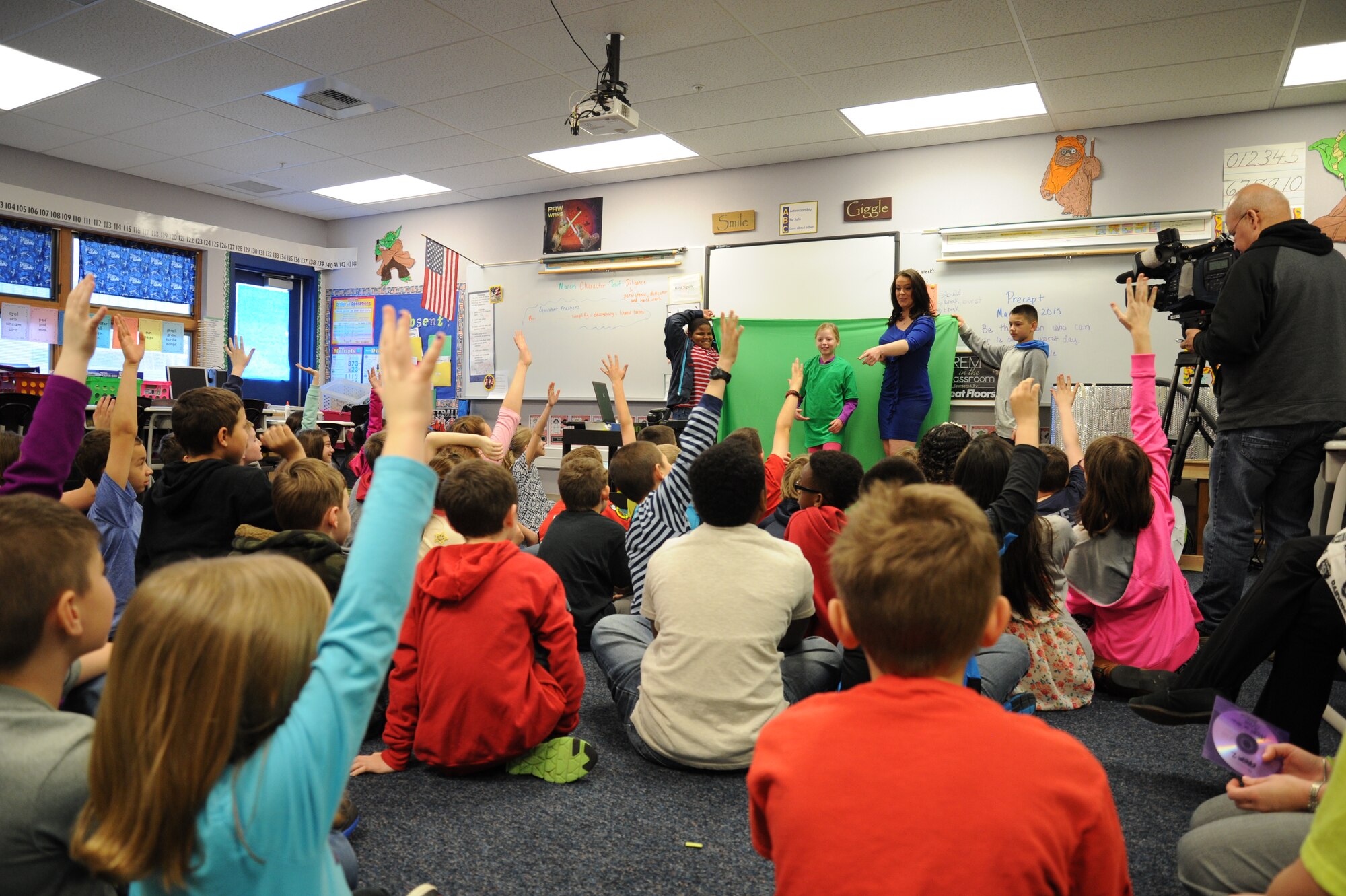 Katie Boer, KREM 2 NEWS weather anchor, shows Michael Anderson Elementary School students the green screen that she works with at the KREM 2 studio March 18, 2015, at Fairchild Air Force Base, Wash. Boer showed the students how the green screen assists her as she predicts the weather. (U.S. Air Force photo/Airman 1st Class Nicolo J. Daniello)