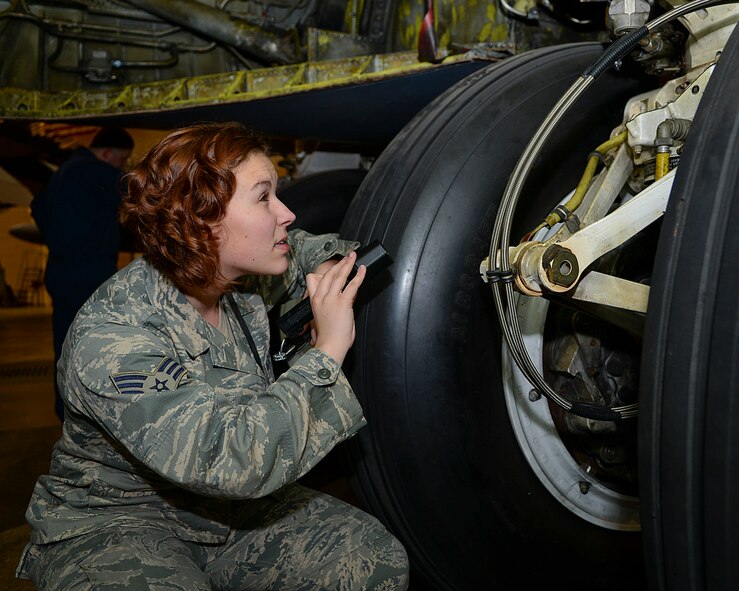 Senior Airman Jasmine Lambert, 2nd Maintenance Squadron hydraulics journeyman, inspects landing gear of a B-52H Stratofortress on Barksdale Air Force Base, March 18, 2015.  Landing gear is inspected for corrosion and safety wire to keep them operating at peak performance. (U.S. Air Force photo/Senior Airman Benjamin Raughton)