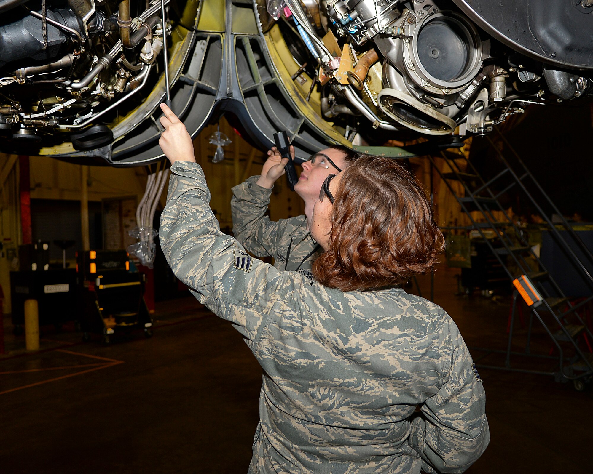 Senior Airman Jasmine Lambert, 2nd and Airman Jake Peladeau, 2nd Maintenance Squadron hydraulics, inspect B-52H Stratofortress engines on Barksdale Air Force Base, La., March 18, 2015. Pumps in the engines provide hydraulic power for various parts of the aircraft. (U.S. Air Force photo/Senior Airman Benjamin Raughton)