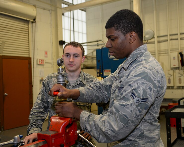Airman 1st Class Christopher Walker, 2nd Maintenance Squadron hydraulics journeyman, disassembles a spoiler actuator on Barksdale Air Force Base, La., March 18, 2015. Fourteen spoiler actuators are responsible for moving B-52H Stratofortress wing flaps. (U.S. Air Force photo/Senior Airman Benjamin Raughton)