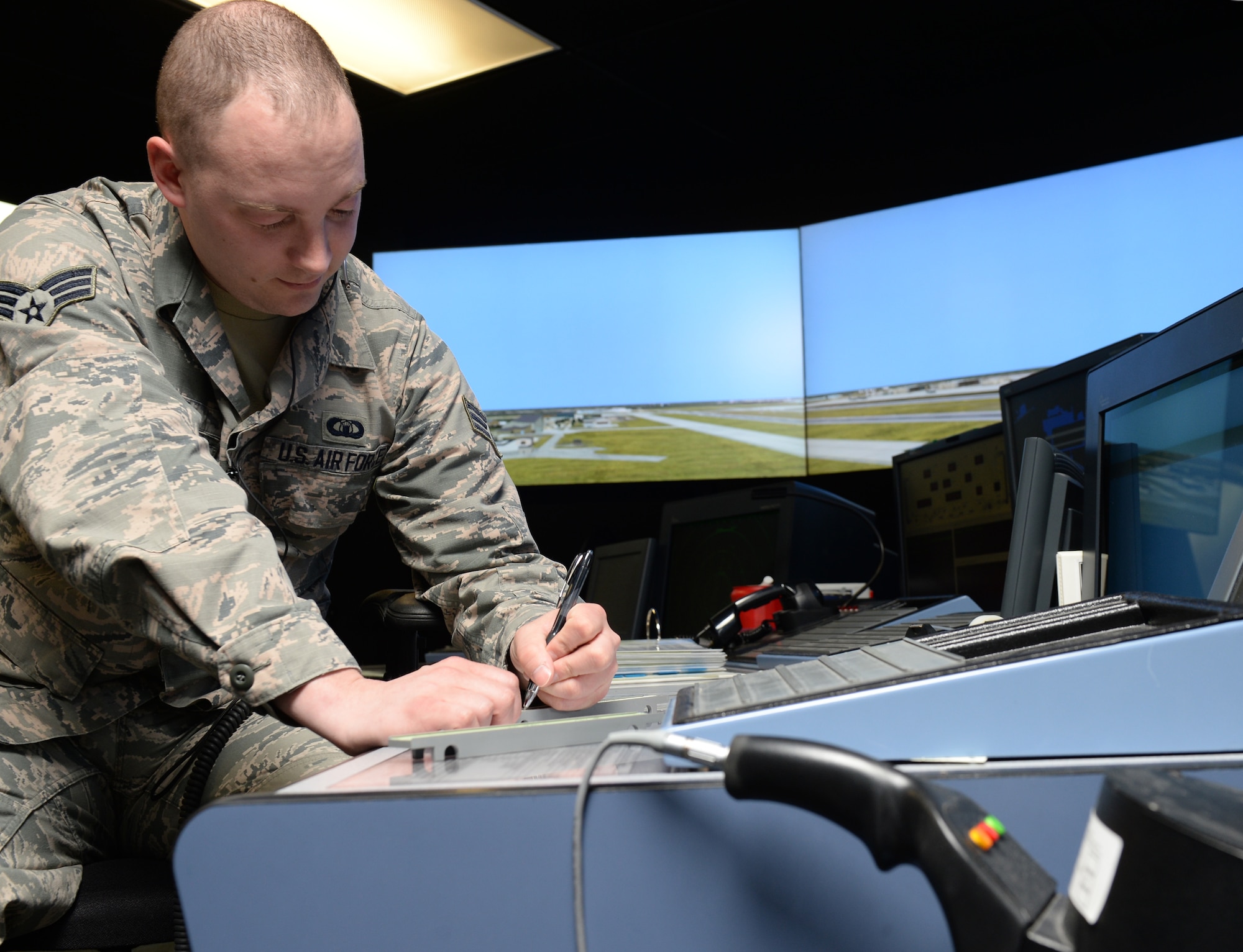 Senior Airman Shane McRae, 22nd Operations Support Squadron air traffic controller journeyman, records data on a flight progress strip, March 18, 2015, in the ATC simulator at McConnell Air Force Base, Kan. McRae was named Air Mobility Command’s 2014 Air Traffic Controller of the Year. (U.S. Air Force photo by Staff Sgt. Rachel Waller)