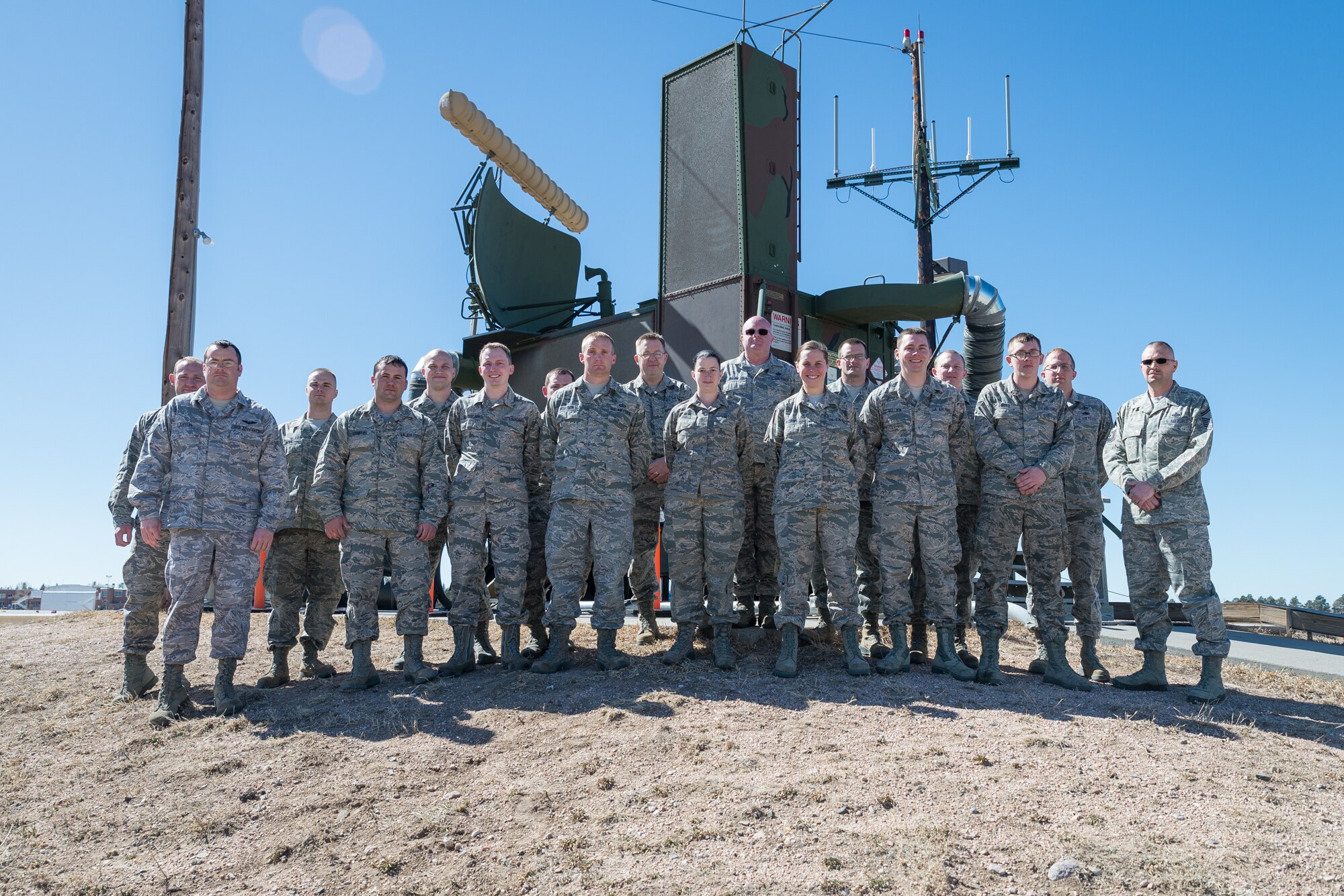 U.S. Air Force Airmen assigned to the 243rd Air Traffic Control Squadron, Wyoming Air National Guard, pose in front of a radar antenna March 10, near Cheyenne Regional Airport in Cheyenne, Wyoming. Members of the Radar and Approach Control were awarded the D. Ray Hardin Air Traffic Control Facility of the Year award for 2014. (U.S. Air National Guard photo by Master Sgt. Charles Delano/released)