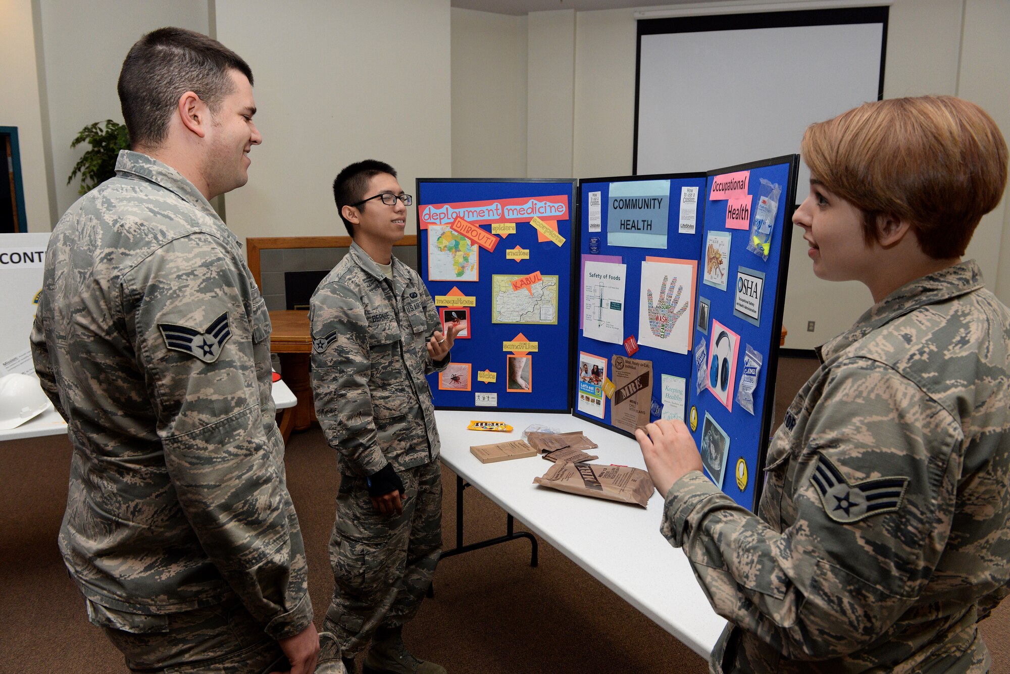 ALTUS AIR FORCE BASE, Okla. – U.S. Air Force Senior Airman Rachel Pavlich, 97th Medical Operations Squadron public health technician, explains the different sections under public health, such as community health, occupational health, and deployment medicine during the career fair at the Freedom Community Center, March 17, 2015. Community health deals with preventative medicine and food inspections, occupational health deals with safety hazards such as making sure people are wearing their personal protective equipment and deployment medicine ensures personnel are medically cleared to deploy. (U.S. Air Force photo by Airman 1st Class Megan E. Acs/Released)