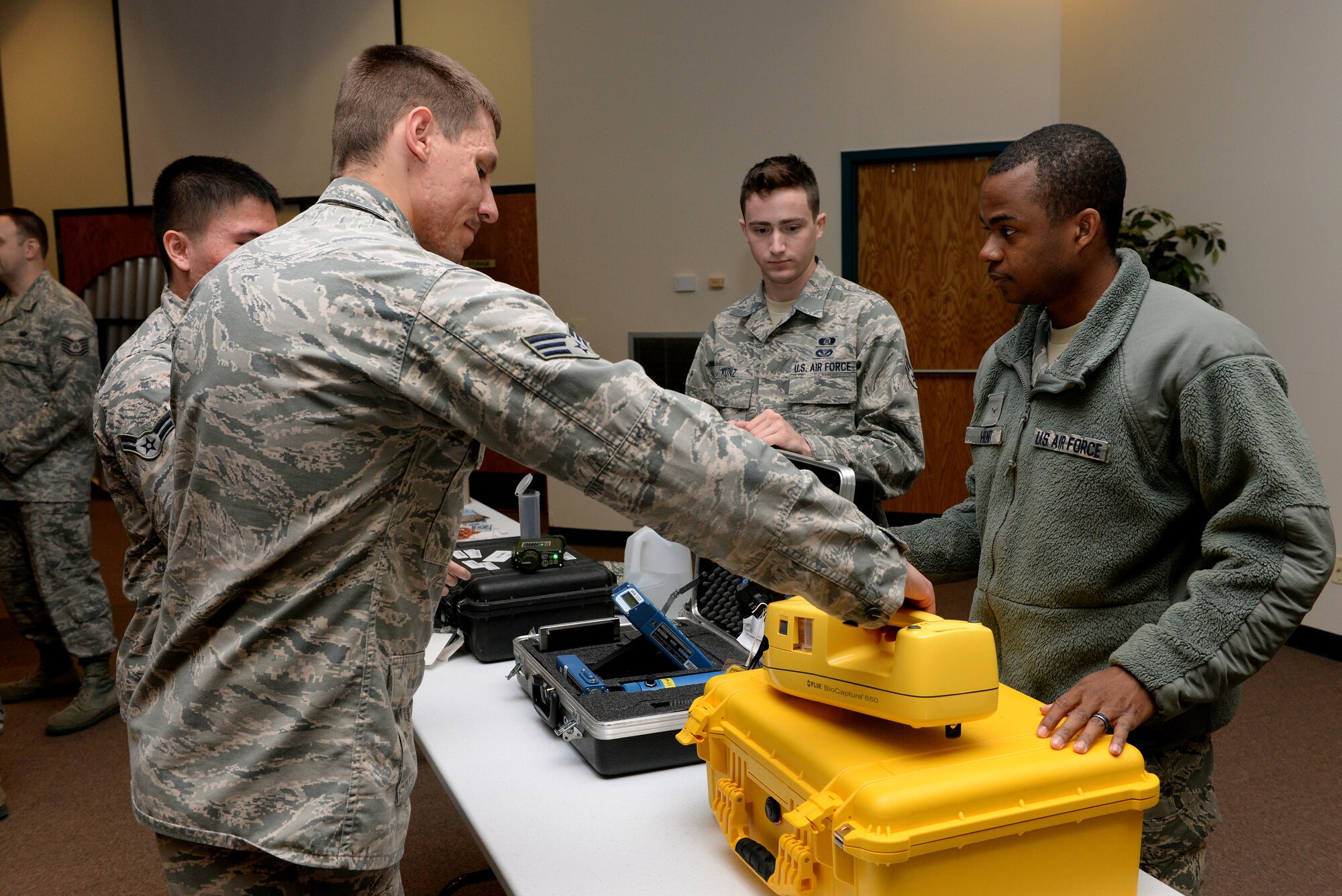 ALTUS AIR FORCE BASE, Okla. – U.S. Air Force Airman Marquis’ Henry, 97th Civil Engineer Squadron emergency management apprentice, explains the basic pieces of equipment used to detect chemical and radioactive threats during the career fair at the Freedom Community Center, March 17, 2015. Some of the equipment on display is used to detect chemical threats or radioactive materials that would be dispersed in explosions, and another machine helps monitor oxygen levels and potential air contaminants. (U.S. Air Force photo by Airman 1st Class Megan E. Acs/Released)