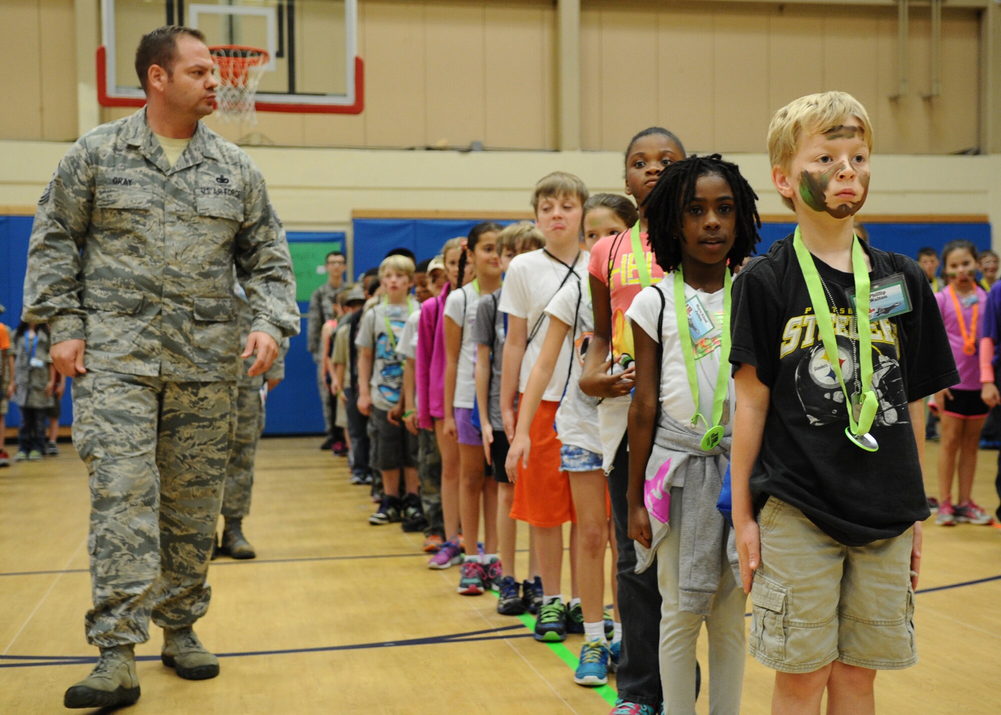 Master Sgt. Sean Gray, 325th Force Support Squadron first. sergeant, instructs and commands children during the Jr. Raptor event March 14 at Tyndall. Children learned orders and facing movements such a right-face, left-face and order arms. (U.S. Air Force photo by Airman 1st Class Ty-Rico Lea/Released)