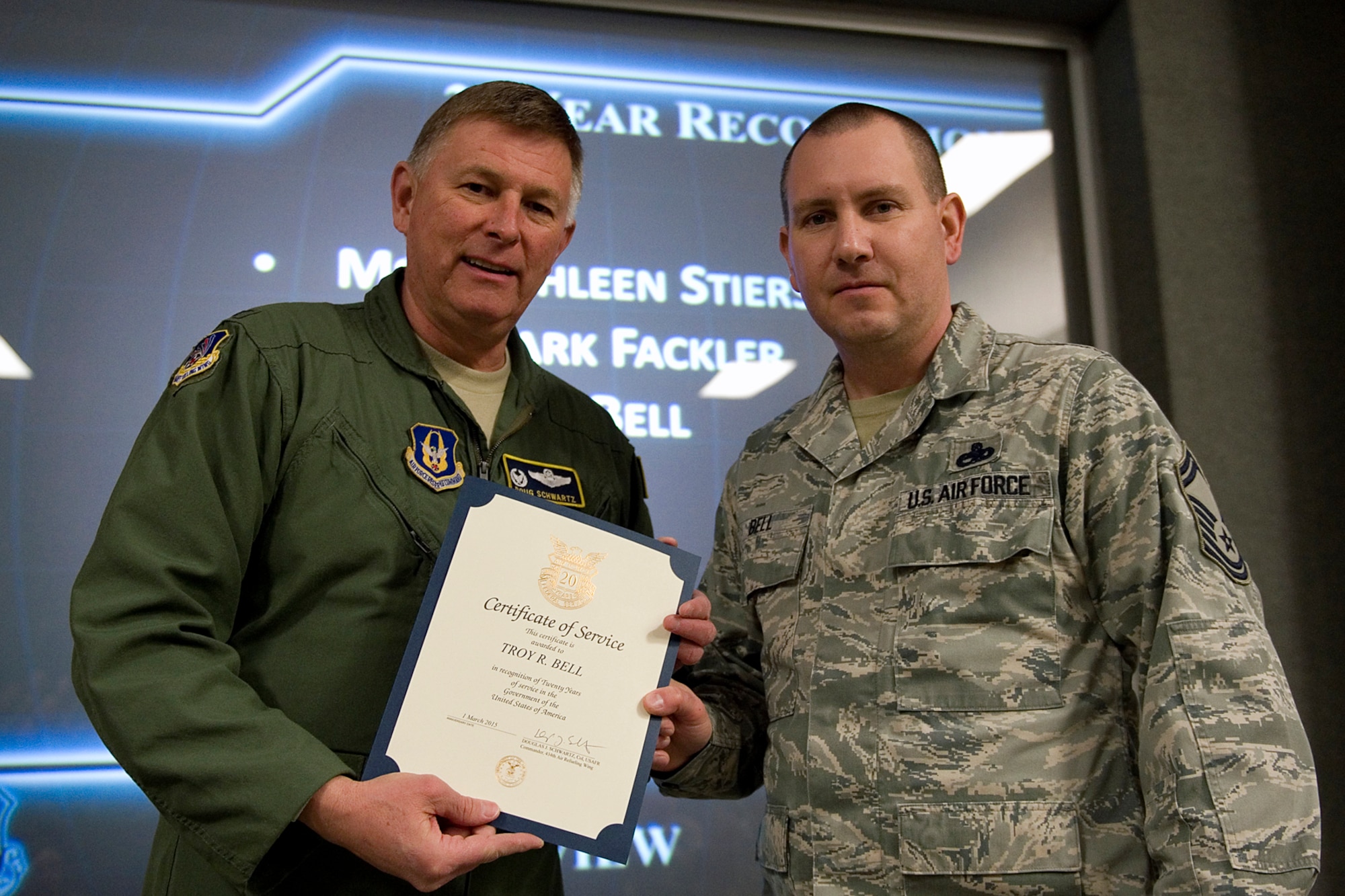 Col. Doug Schwartz, 434th Air Refueling Wing commander, presents Senior Master Sgt. Troy Bell, 434th Aircraft Maintenance Squadron, with a certificate of service for completing 20 years as a federal employee during a civilian commander's call at Grissom Air Reserve Base, Ind., March. 13, 2015. Civil service employees are an essential part Grissom and serve critical roles in maintaining unit readiness and daily operations. (U.S. Air Force photo/Tech. Sgt. Benjamin Mota)