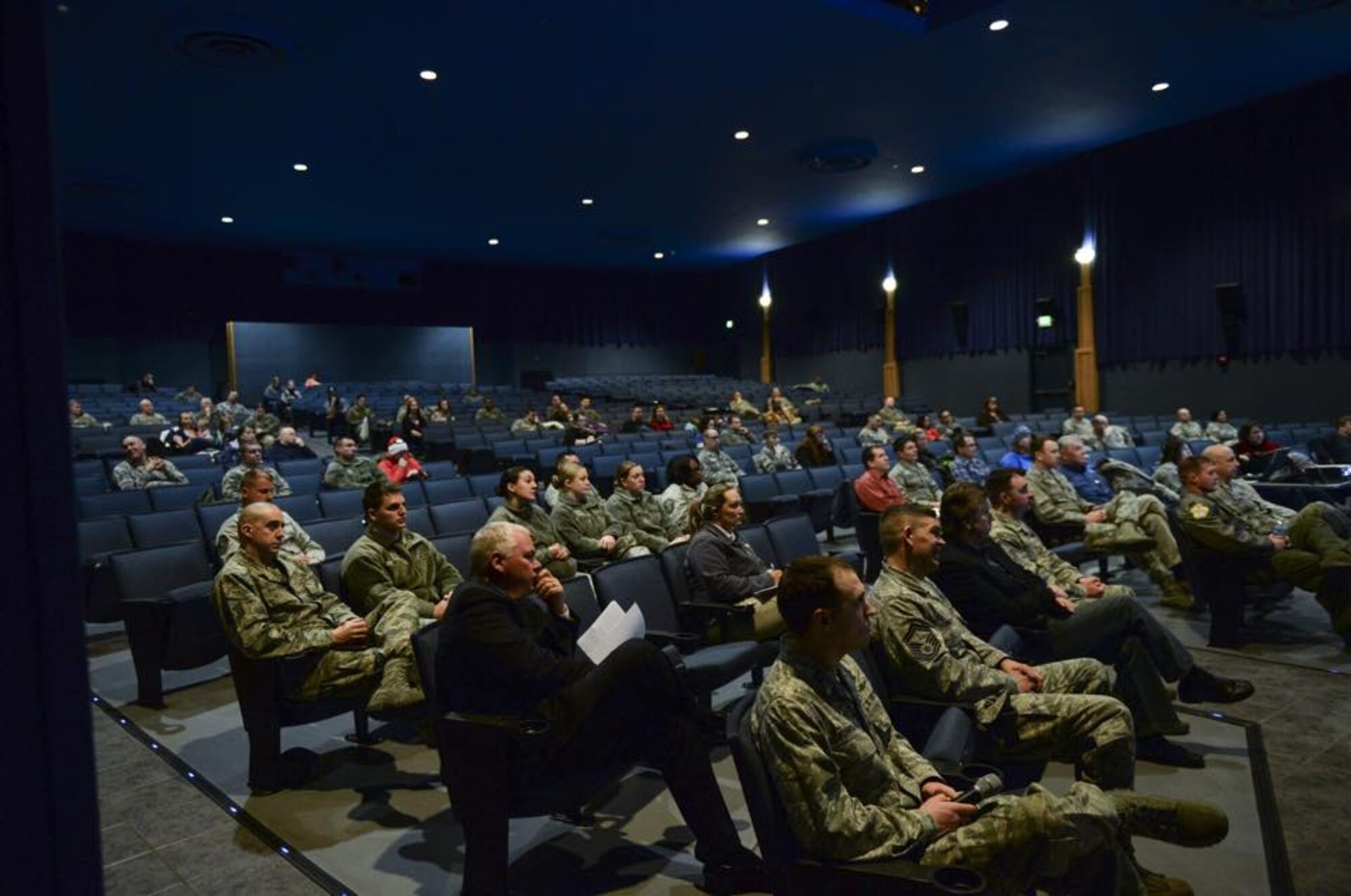 Eielson housing residents listen to leaders address upcoming changes to the French Creek and Moose Lake housing areas at the Ernie Walker Theater, Eielson Air Force Base, Alaska, March 12, 2015. Base leaders held a town hall meeting to inform residents of ongoing construction projects to help bring reliable heat to older infrastructure. (U.S. Air Force photo by 1st Lt. Elias Zani/Released)