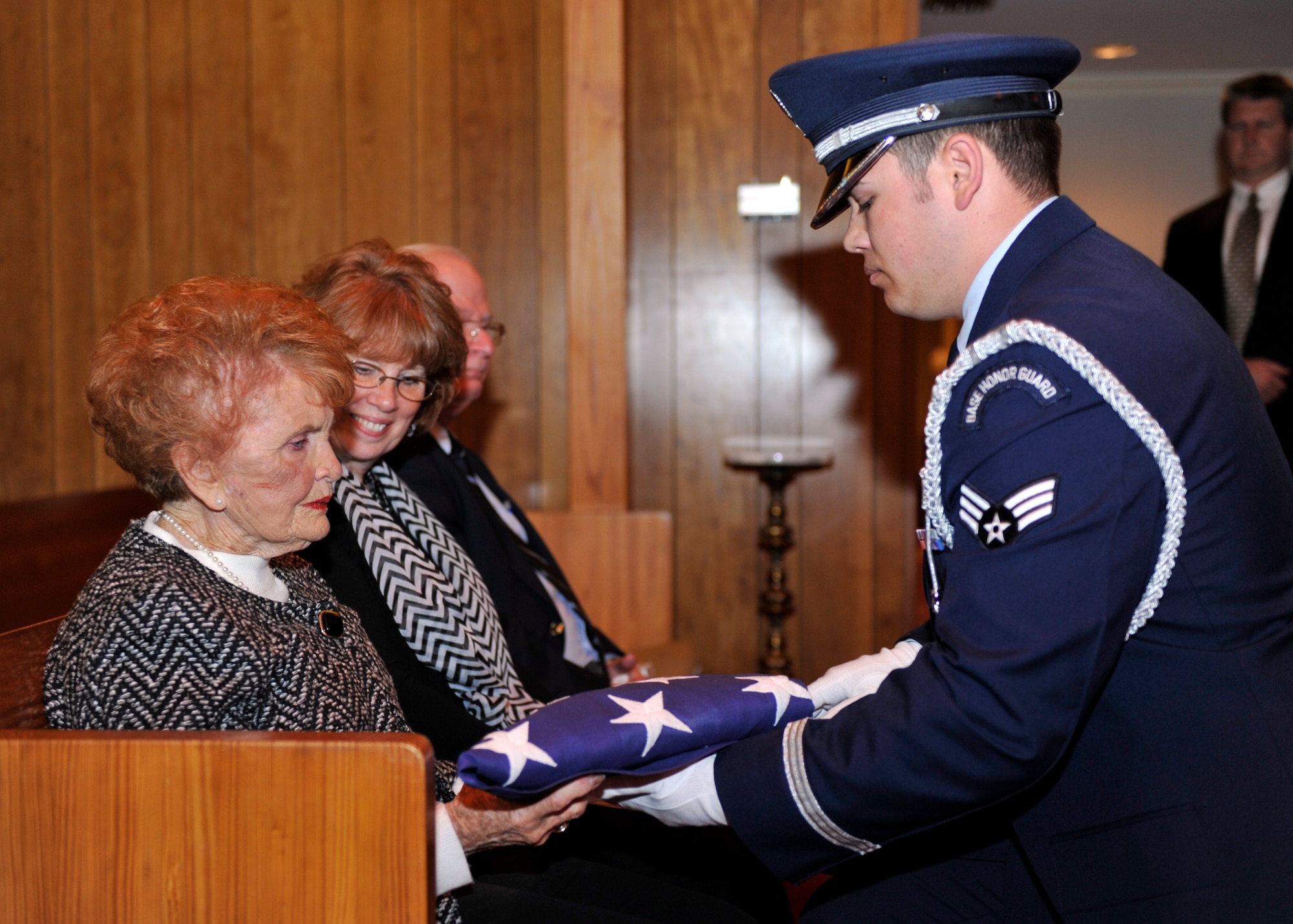 A Tyndall Honor Guard member presents the U.S. flag to the family of U.S. Air Force Col. (Ret.) Robert “Don” Gregor March 1 at the Wilson Funeral Home Chapel in Panama City, Fla. during his funeral. Gregor was the Tyndall base commander and the vice commander of the Weapons Center at one point in his career. (U.S. Air Force photo by Airman 1st Class Sergio A. Gamboa/Released)
